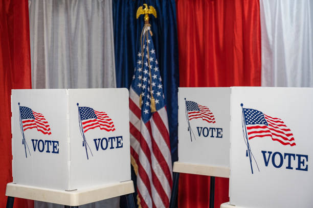 istock Three empty voting booths with bunting and American flag 1412572467
