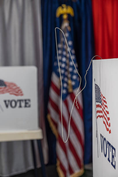 istock An opened metal coat hanger hanging from voting booth 1412572532