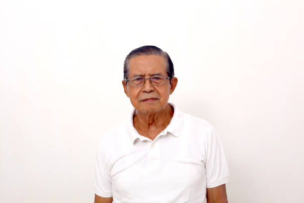 Portrait of Asian man standing while looking at camera. Isolated on white background with copyspace
