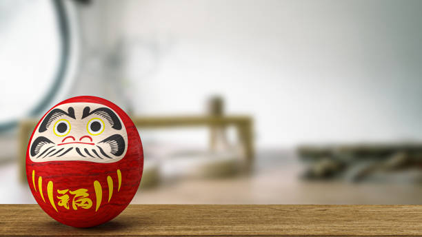 istock daruma Japanese doll on wood table 3d rendering 1412575929