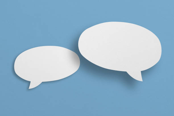 istock white paper with speech bubbles isolated on blue background communication bubbles 1412576464