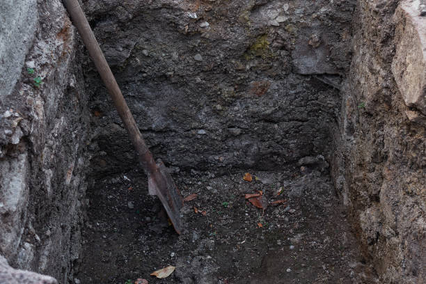 istock A dirty rusty shovel with a wooden handle stands in a pit. 1412576797