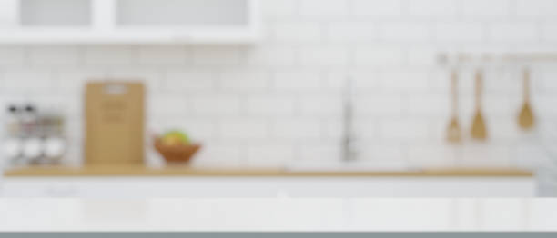 istock Empty mockup space on kitchen countertop over blurred minimal kitchen in the background 1412577720
