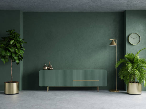 濃い緑色の壁の背景にテレ��ビ用のキャビネット付きのリビングルーム。 - contemporary indoors sparse living room ストックフォトと画像