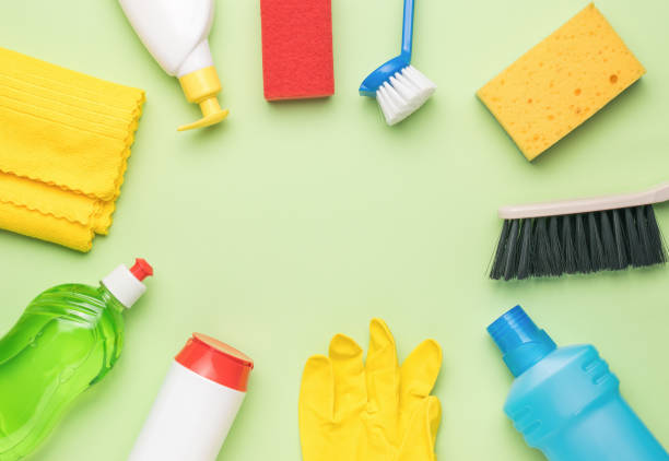 istock Cleaning products on a light green background with a place for text. Cleaning kit. 1412578811