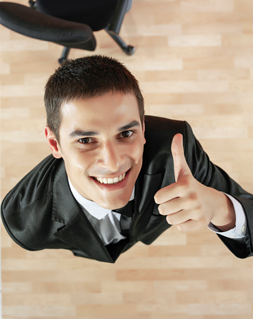 Young businessman making an OK sign