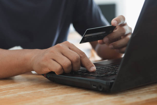 istock Businessman using laptop computer with a credit card making an online order. Business, online shopping, e-commerce, internet banking, spending money, online payment, working from home concept. 1412582537