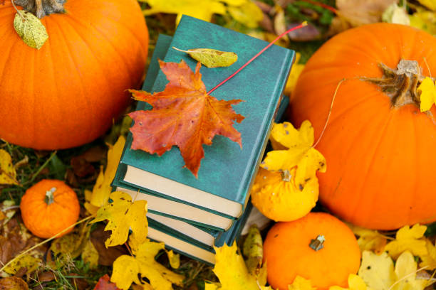 istock back to school.Study and education concept.Autumn books.Halloween books. Autumn reading.Stack of books,pumpkins on the autumn garden background .Cozy autumn mood. 1412583452