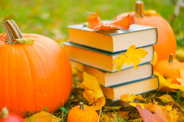 istock back to school.Study and education concept.Autumn books.Halloween books. Autumn reading.Stack of books,pumpkins on the garden background .Cozy autumn mood.Reading in the autumn day. 1412583501