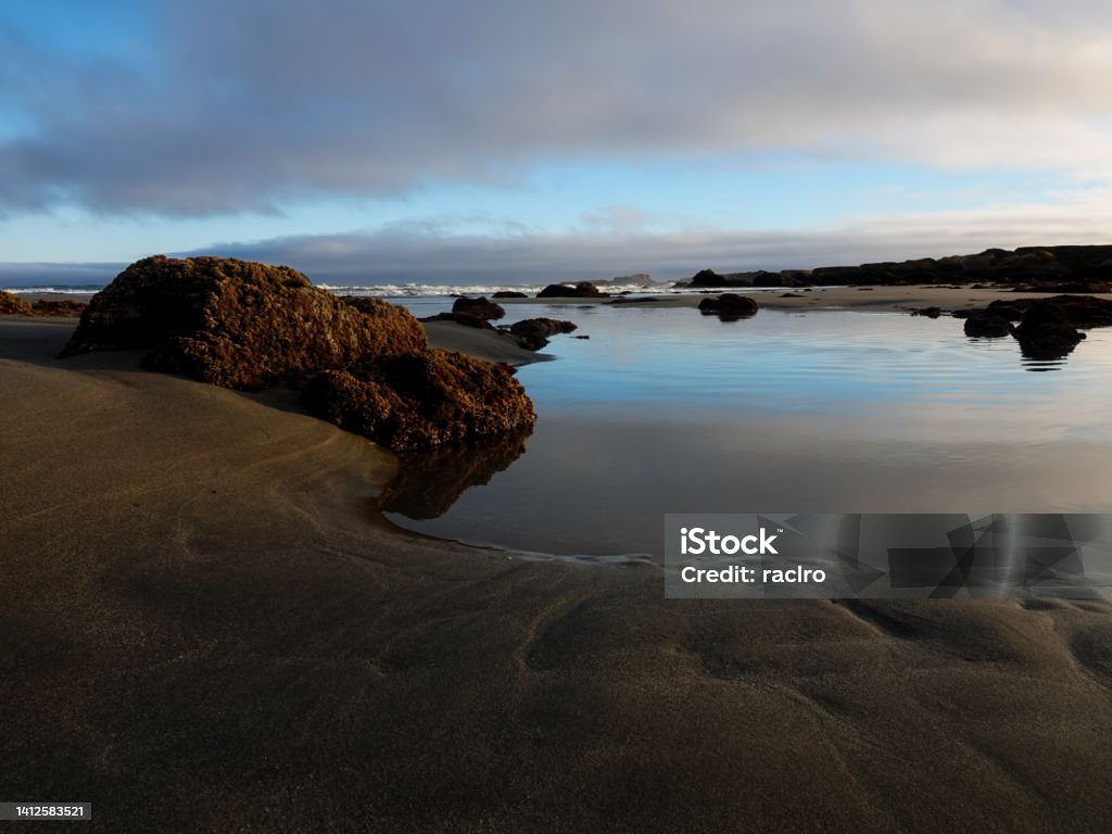 California beach and tide-pools in early morning light. Beach Stock Photo