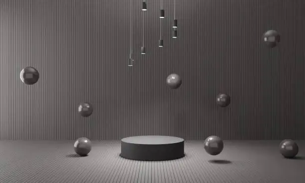 black podium with hanginglight and ball in black room.3d rendering.