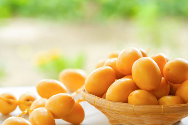 Fresh yellow dates in a basket on the table.
