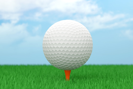 Close-up of flying golf ball over blurred course