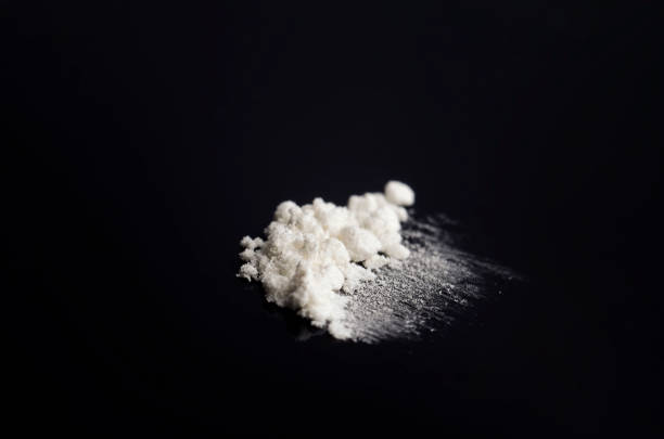 istock White drug on a black background 1412592665