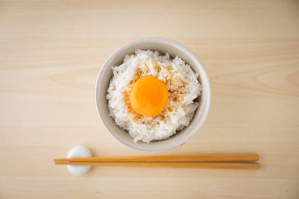 istock Tamagokake gohan, raw egg yolk on white rice, japanese breakfast 1412593386