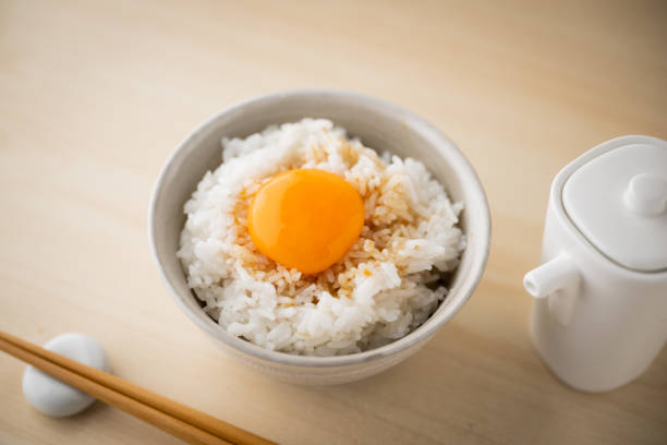 istock Tamagokake gohan, raw egg yolk on white rice, japanese breakfast 1412593417