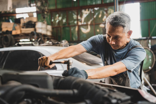 istock mechanic working and check about auto car engine service, inspection technician having automotive job to maintenance or repair automobile in motor garage, business industrial auto car engine 1412593527