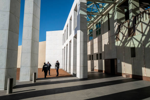 Canberra, ACT, Australia - 25 June 2015: An elevated view down Commonwealth Avenue towards the Australian Parliament House and Old Parliament House in Canberra, under soft evening light.