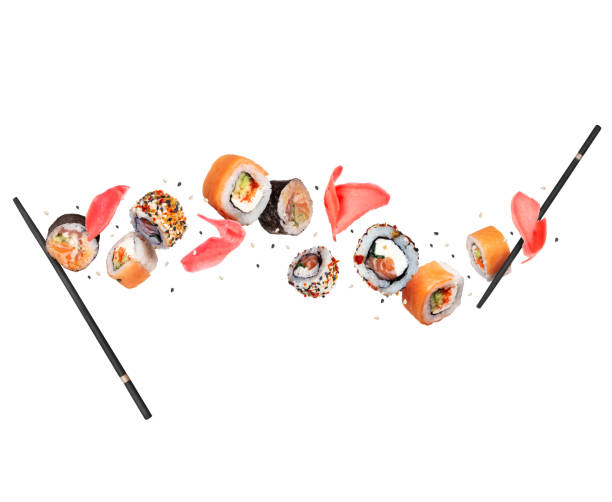 istock Fresh sushi rolls with ginger in the air isolated on a white background 1412598364