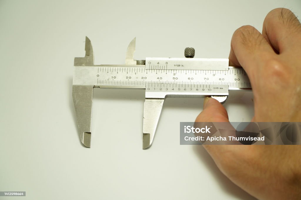 Vernier caliper and engineer's hand isolated on white background,Vernier caliper and scale. Measuring tool and equipment,Gauge Blocks Precision Metric Caliper Stock Photo