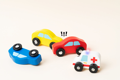 Three mini toy car crash. Ambulance and police car on the
