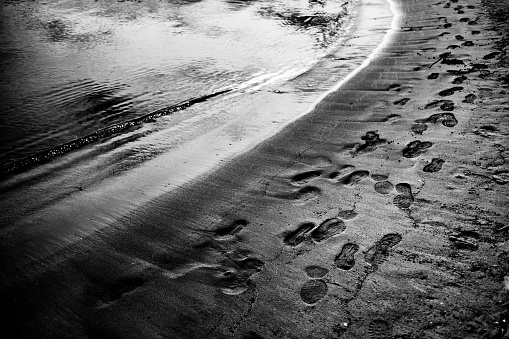 Image of footprints on the beach and sand