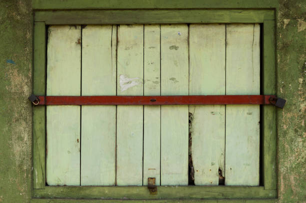 Shop window locked and closed by red iron bar