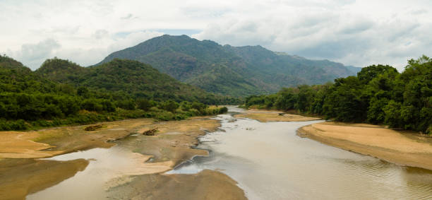 istock River with not much water in hilly tropical landscape 1412605222