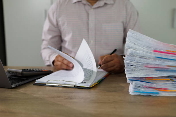 istock Businessman manager hands writing signing in paperwork or documentation documents on office desk 1412605257