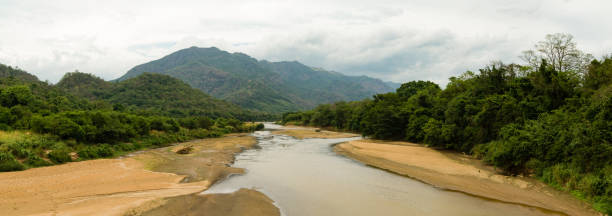 istock River with not much water in hilly tropical landscape 1412605351