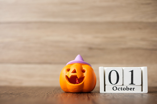 Happy Halloween day with Jack O lantern pumpkin and 1 October calendar. Trick or Threat, Hello October, fall autumn, Festive, party and holiday concept
