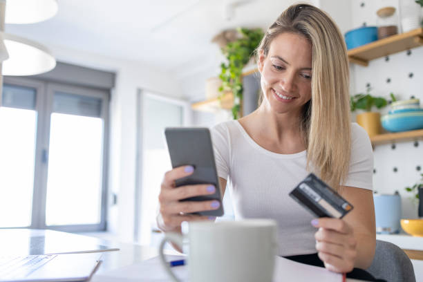 istock Happy young woman shopping online 1412609183