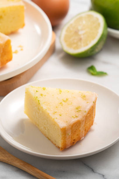 istock Delicious Lemon Glazed Pound Sponge cake on white marble table background. 1412609446