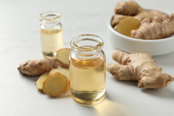 istock Glass bottle of essential oil and ginger root on white table 1412610627