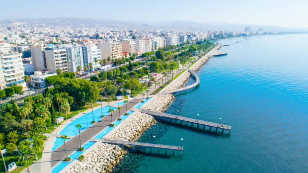 Aerial view of Molos, Limassol, Cyprus Aerial view of Molos Promenade park on the coast of Limassol city centre in Cyprus. Bird's eye view of the jetties, beachfront walk path, palm trees, Mediterranean sea, piers, rocks, urban skyline and port from above. limassol stock pictures, royalty-free photos & images