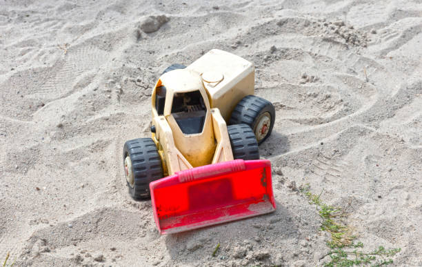 istock Dump truck toy working on the sand 1412610885