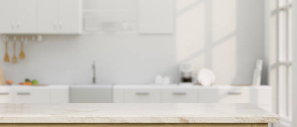 istock Elegance white marble kitchen tabletop with copy space over blurred white kitchen in background 1412613098