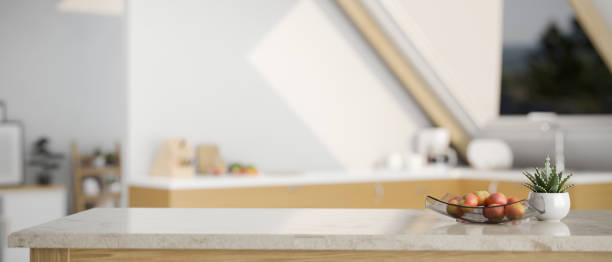 istock Modern marble kitchen tabletop with decors and copy space over blurred minimal bright kitchen 1412613113