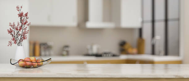 istock Luxury marble kitchen countertop with copy space over blurred modern kitchen in background 1412613115