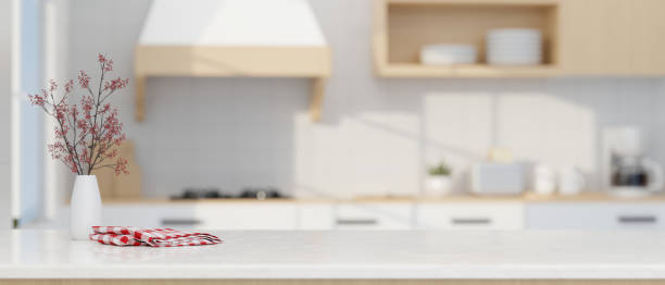 istock Modern luxury white kitchen tabletop with decors and copy space over blurred modern kitchen space 1412613129