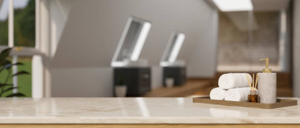 istock Marble tabletop with towels, shampoo bottle, aroma diffuser and copy space over blurred modern spa 1412613294