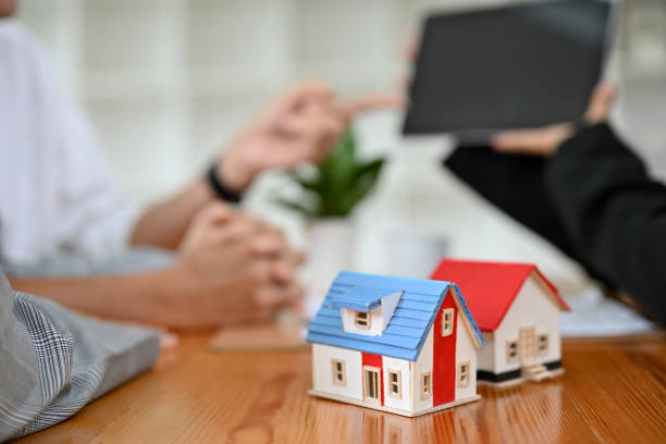 istock A house model is on the meeting table over a blurred background. cropped image 1412614728