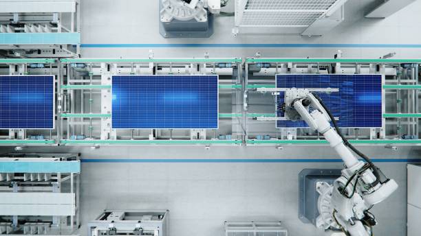 draufsicht auf die montagelinie von solarmodulen mit roboterarmen in der modernen hellen fabrik. produktionsprozeß für solarmodule in einer automatisierten anlage - conveyor belt fotos stock-fotos und bilder