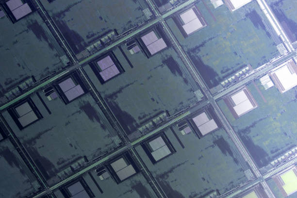 istock Silicon wafer with microchips used in electronics for the fabrication of integrated circuits. Full-frame high-tech macro background. 1412615552