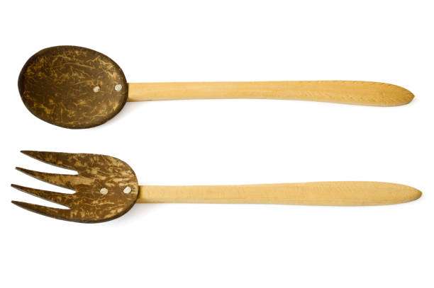 istock Handmade coconut shell and wooden fork and spoon on white background 1412615555