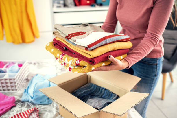 istock Woman putting her clothes in a delivery box 1412616423
