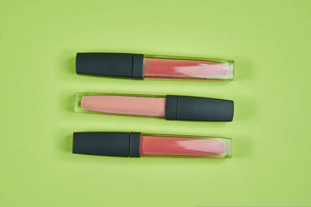 istock three lipsticks of different colors pattern on a green background isolated 1412616736