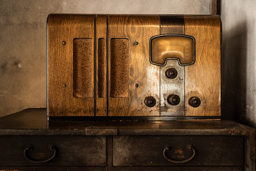 A tight shot of an old Japanese wooden radio.