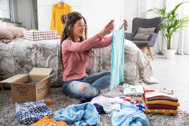 istock Woman putting clothes in a donate box 1412618032