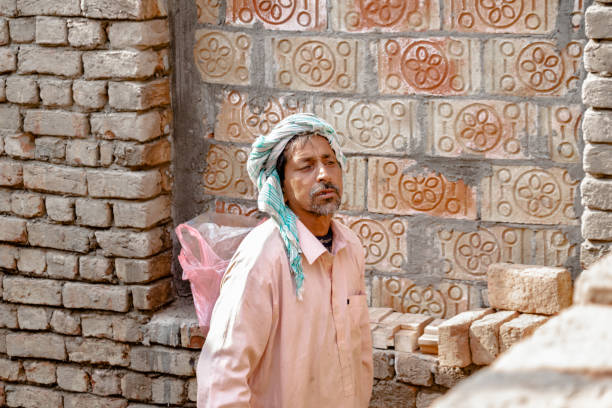 istock a worker is feeling very tired at a construction site and wearing turbine 1412618068